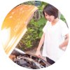 Woman standing next to car with hood open